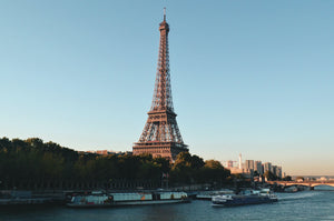 an Image of the Eiffel Tower viewed from across a canal