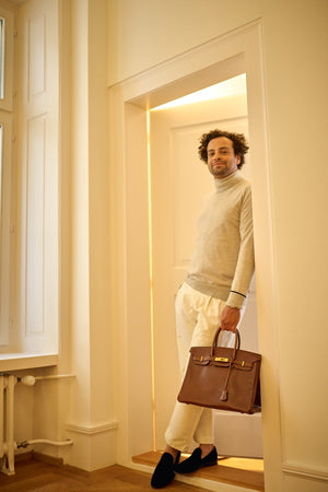 man with an hermes birkin bag